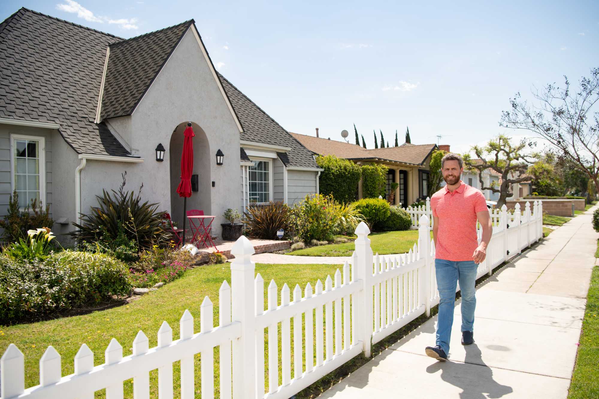 Residential home with a well-kept front garden and fence